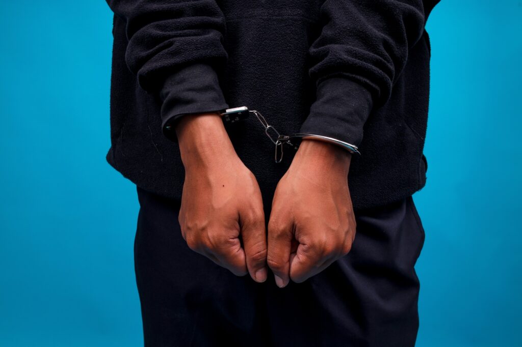 Hands In Handcuffs Closeup View. Crime, Arrest And Jail Concept