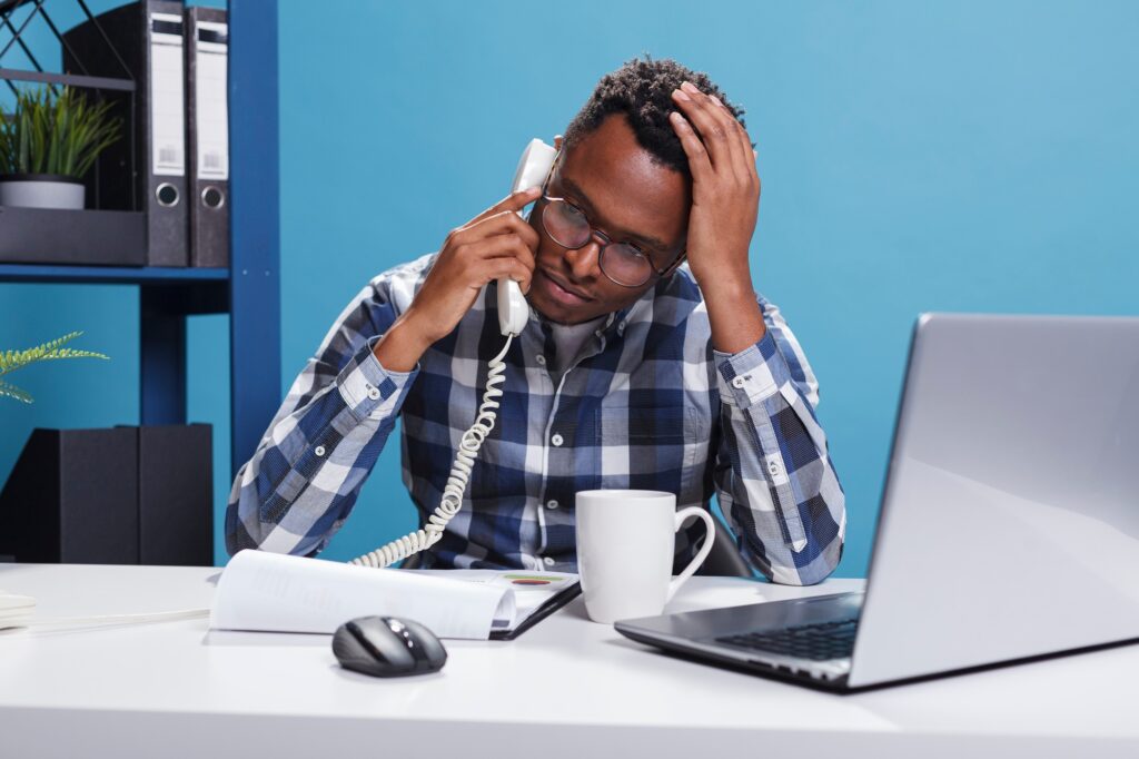 Worried and nervous project manager on phone call with executive officer